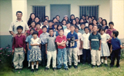 A photo of Julio with his parents and many of the children who are either living in, or formerly lived, in the González home