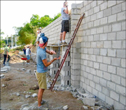 A photo of some of the members of the CAA/Vancouver SDA mission group building their part of the cinder block wall which will eventually enclose the campus while volunteering at the ICC project in El Salvador