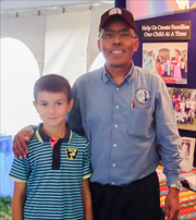 Photo of Joel Reyes and a young supporter of ICC
