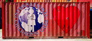 photo illustration of a red shipping container with the ICC logo and a giant heart painted on the side