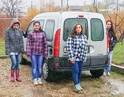 photo showing kids from ICC Romania standing around the new minivan